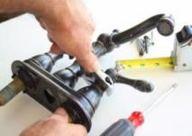 plumber in Garland Texas tightens faucet handles with a crescent wrench for an installation