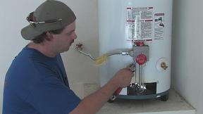 A Professional Contractor Repairing the Intake Valve on a Water Heater